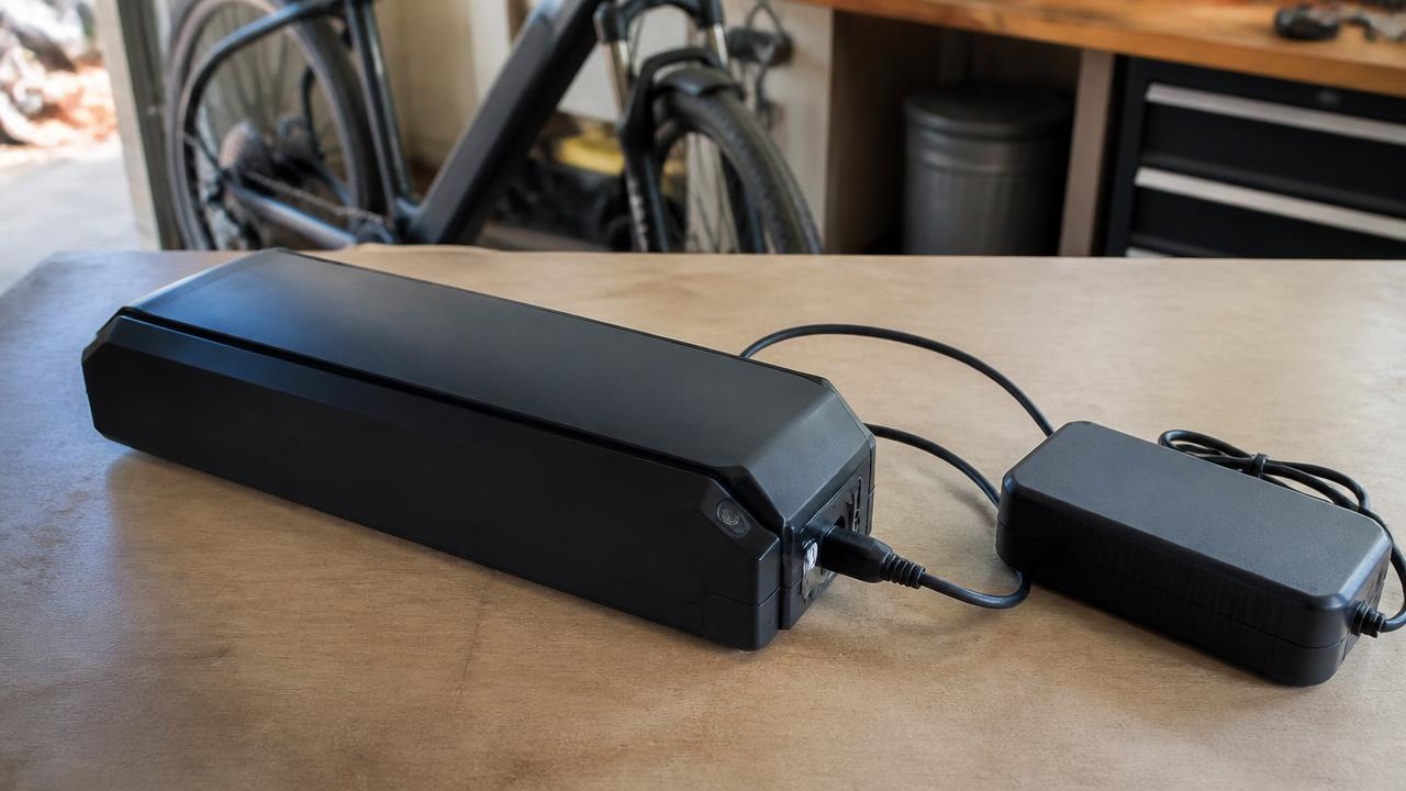 E-bike battery pack and charger on a workbench